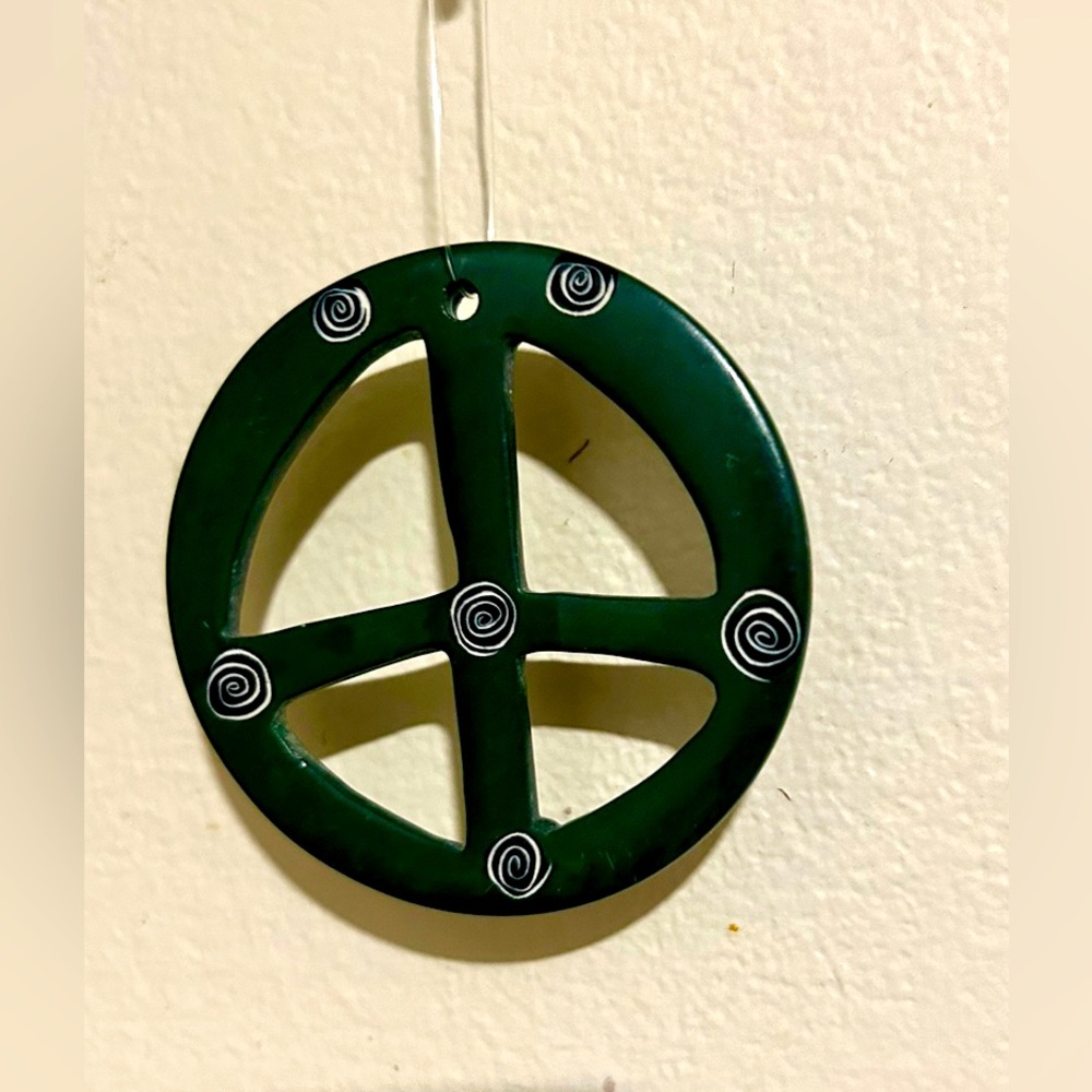 Unique Green Ornament Circle with Swirls engraved looks to be handmade folk